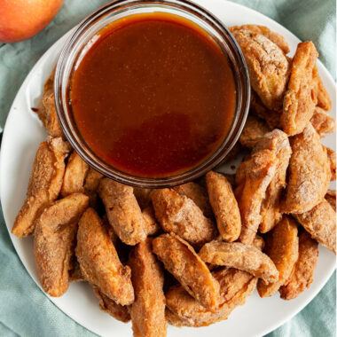 air fryer apple fries on a plate with caramel sauce