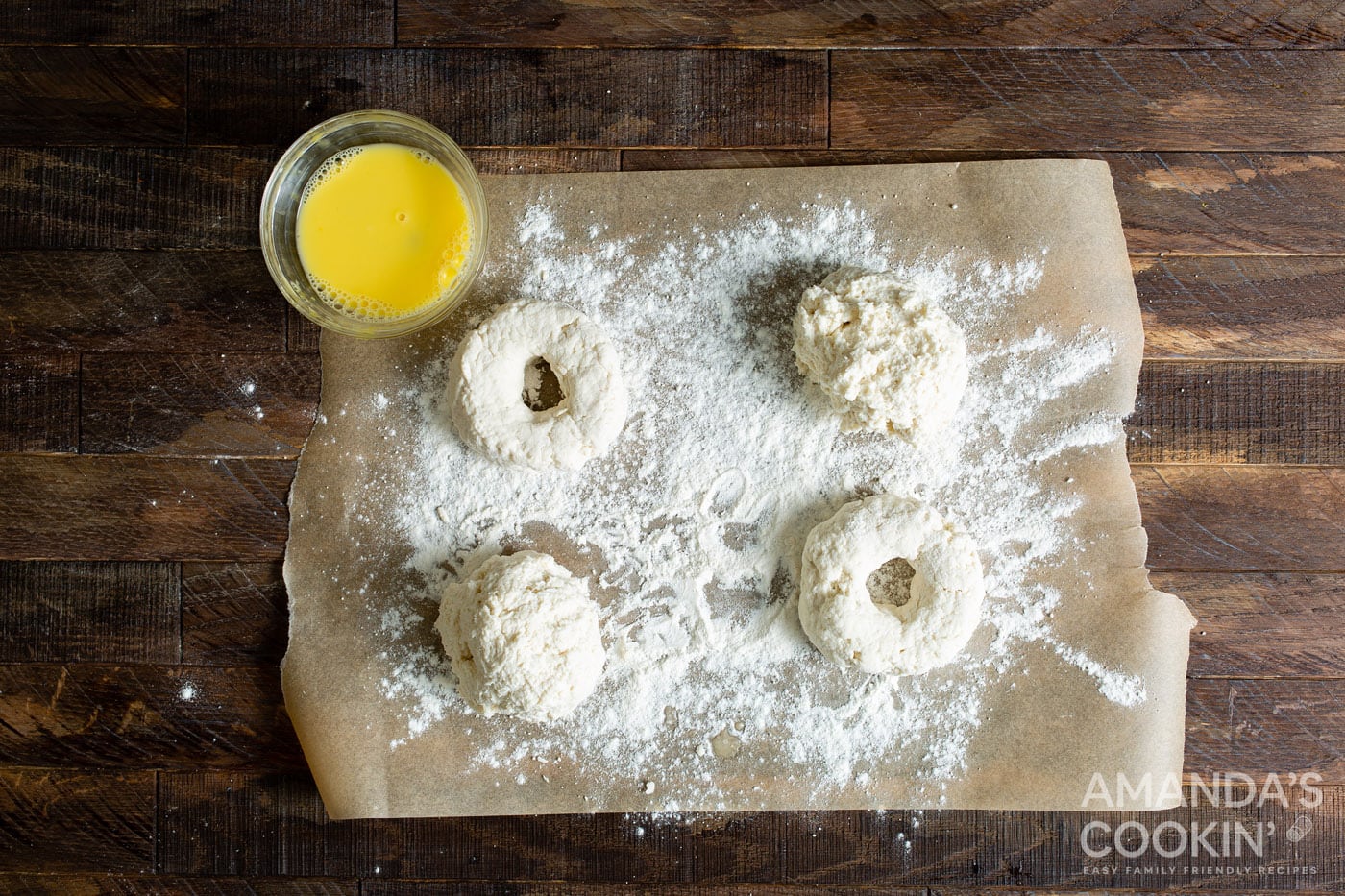 raw air fryer donuts on parchment with flour