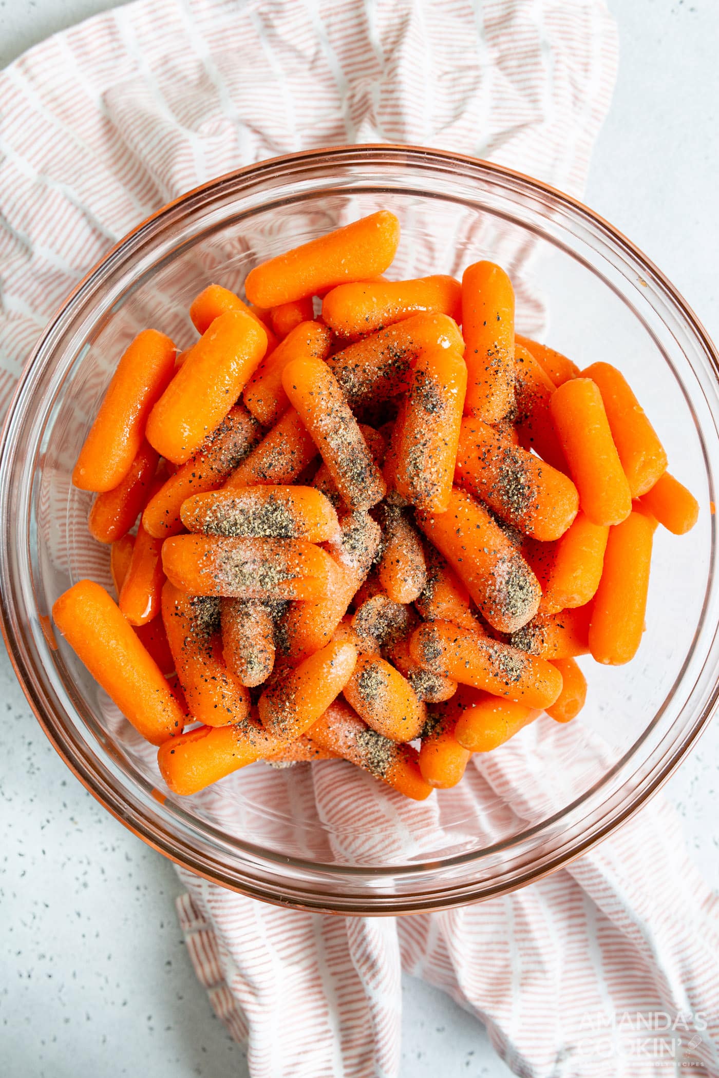 carrots in a bowl with seasonings