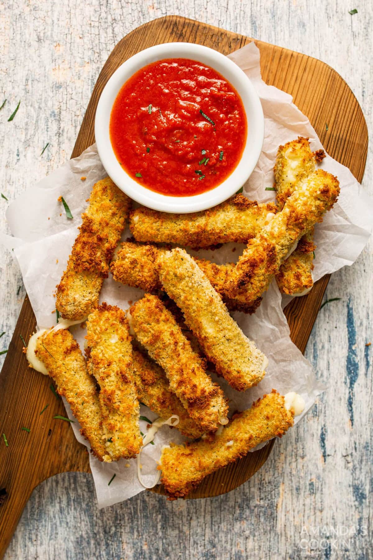 a bunch of air fried mozzarella sticks with marinara