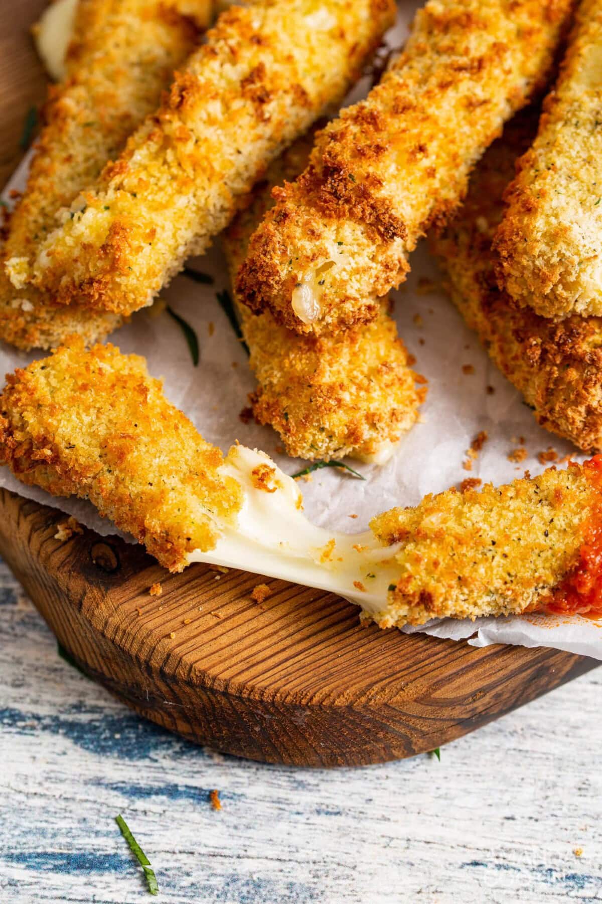 melty mozzarella stick on a cutting board