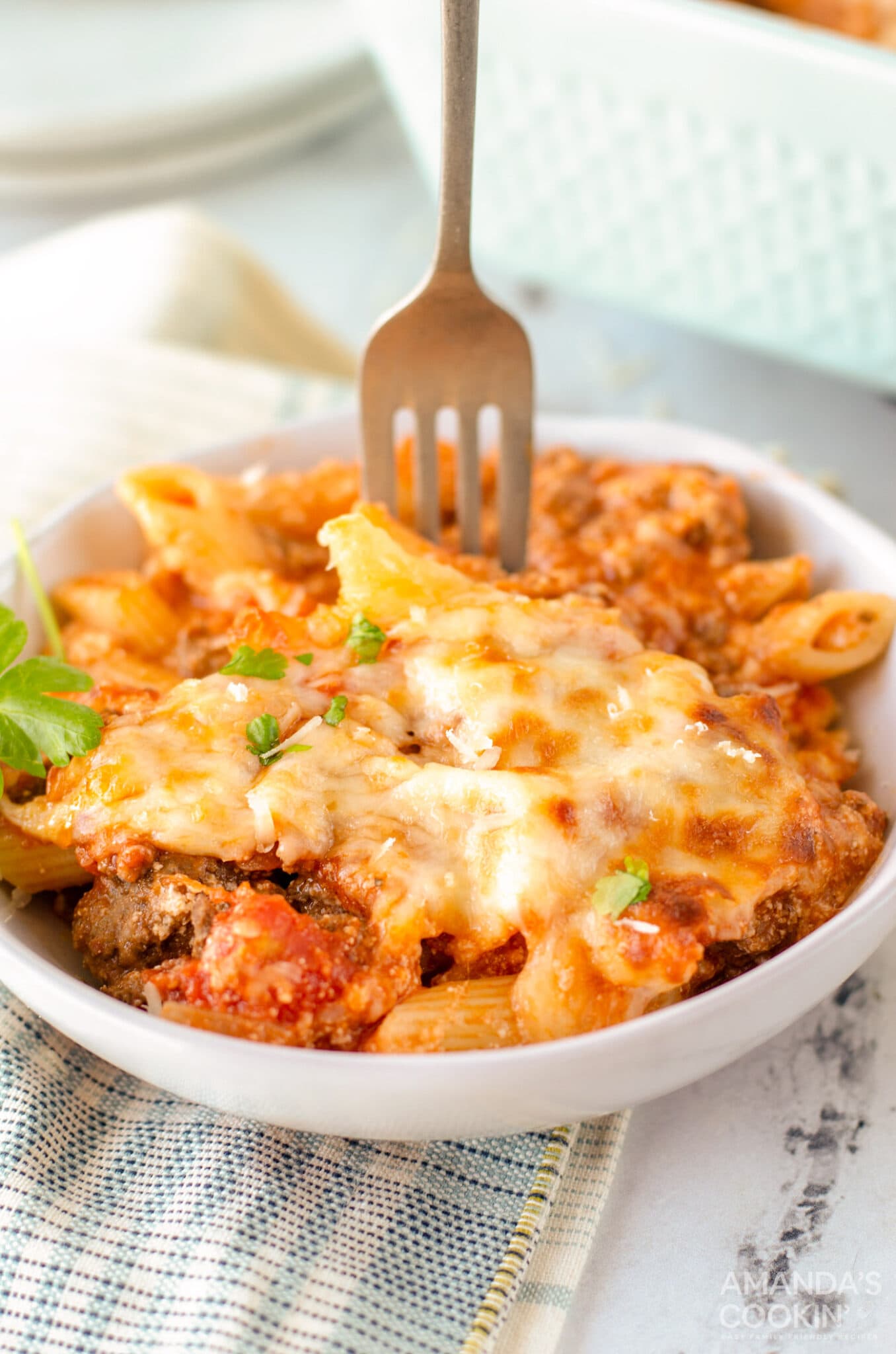 fork in a bowl of baked ziti