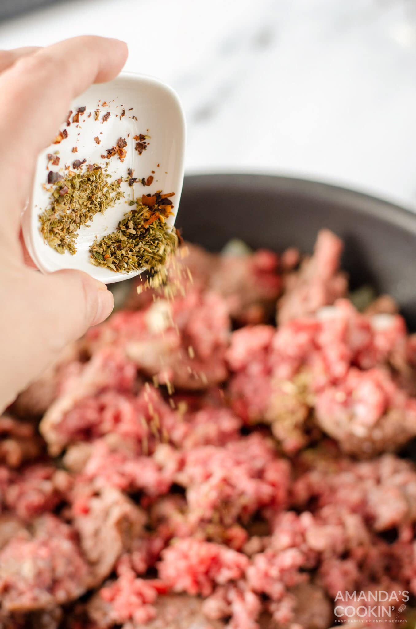 adding spices to pan