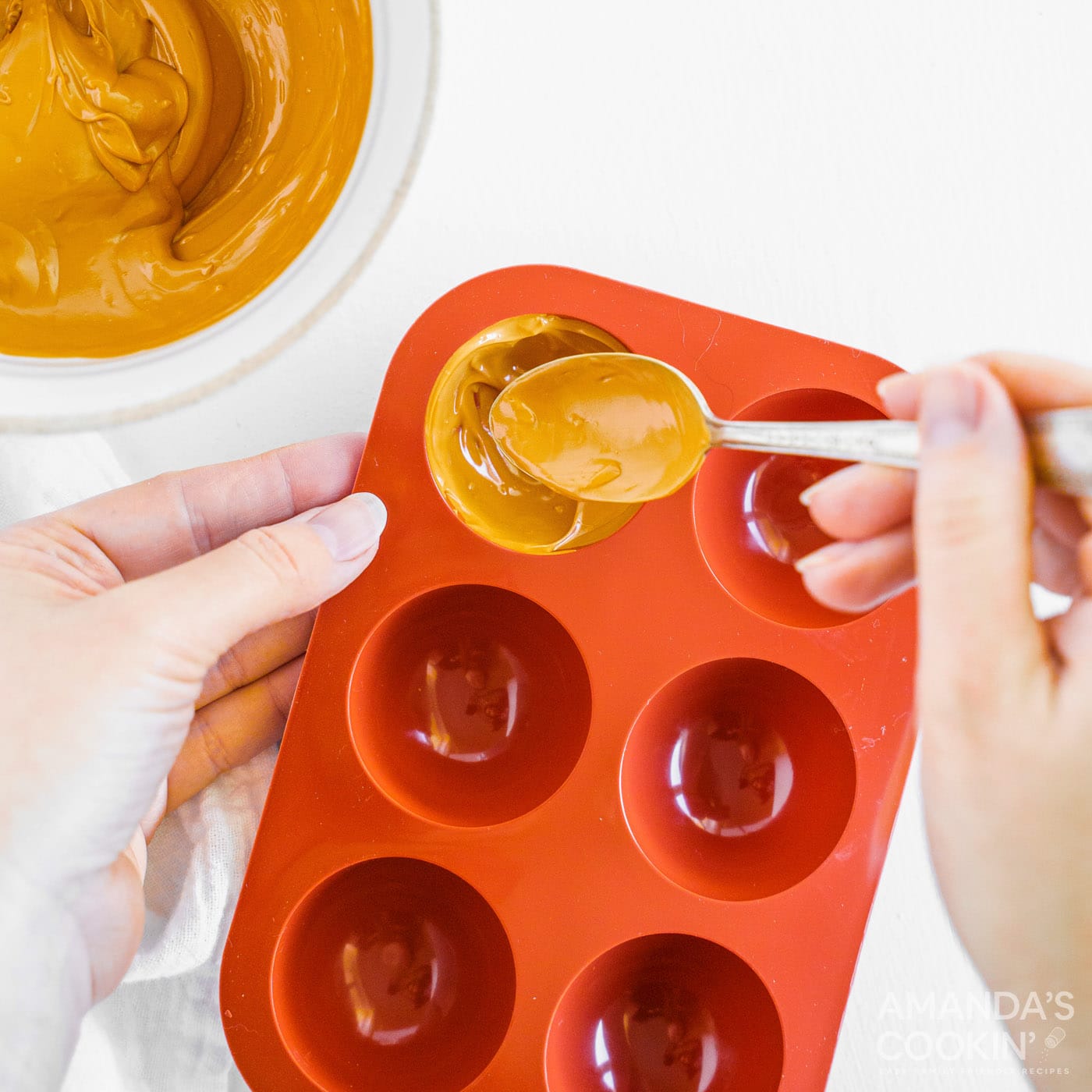 adding melted candy to cocoa bomb molds