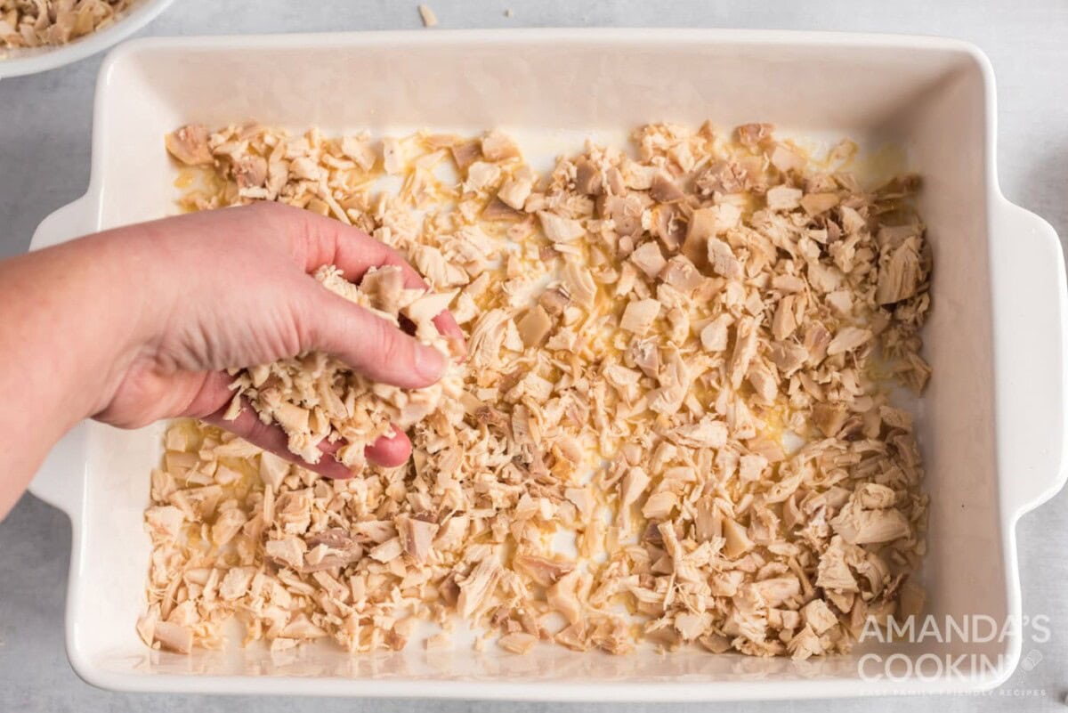 adding chicken to buttered pan