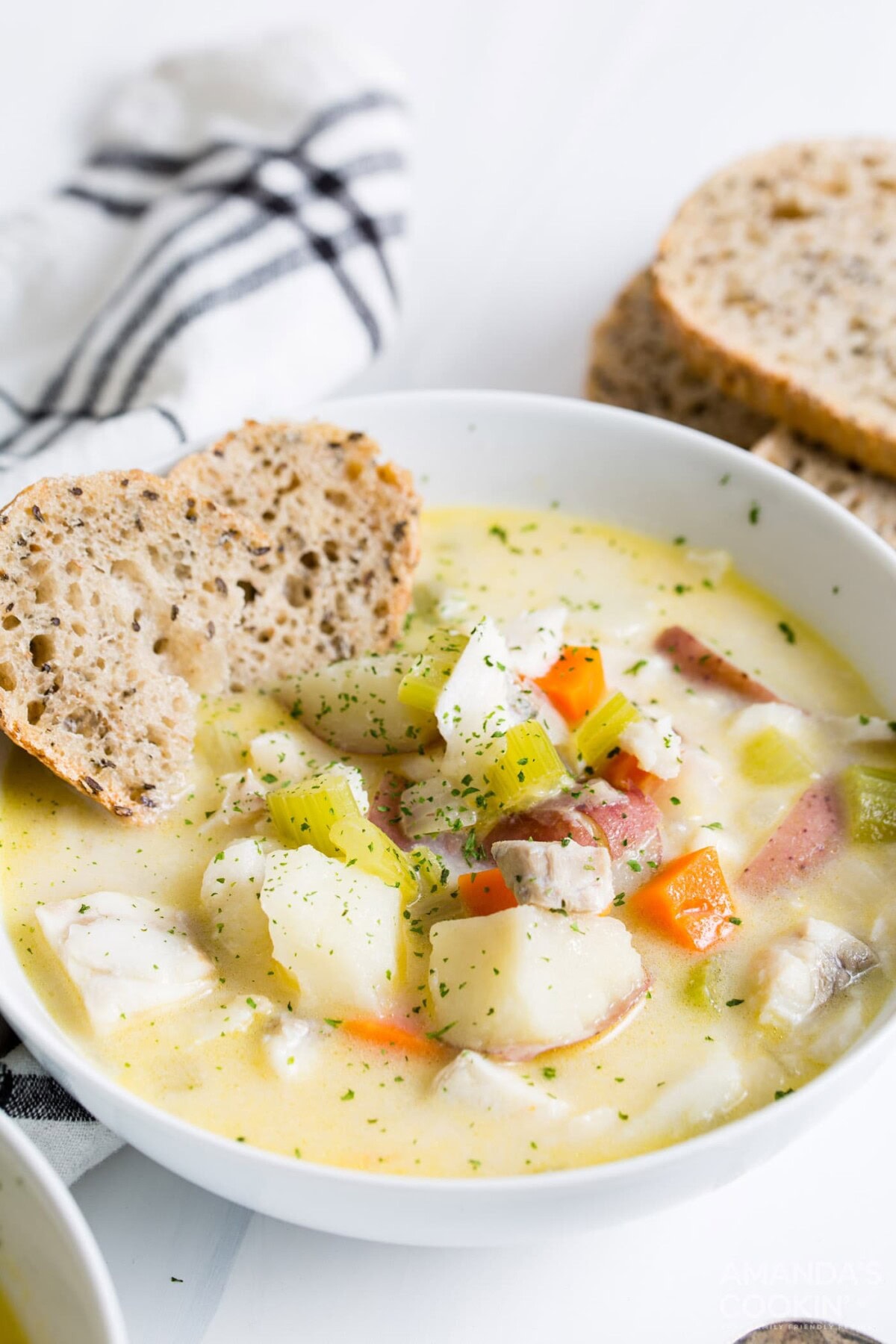 bowl of fish chowder with side of bread