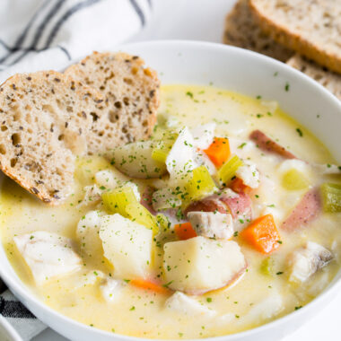 bowl of fish chowder with side of bread