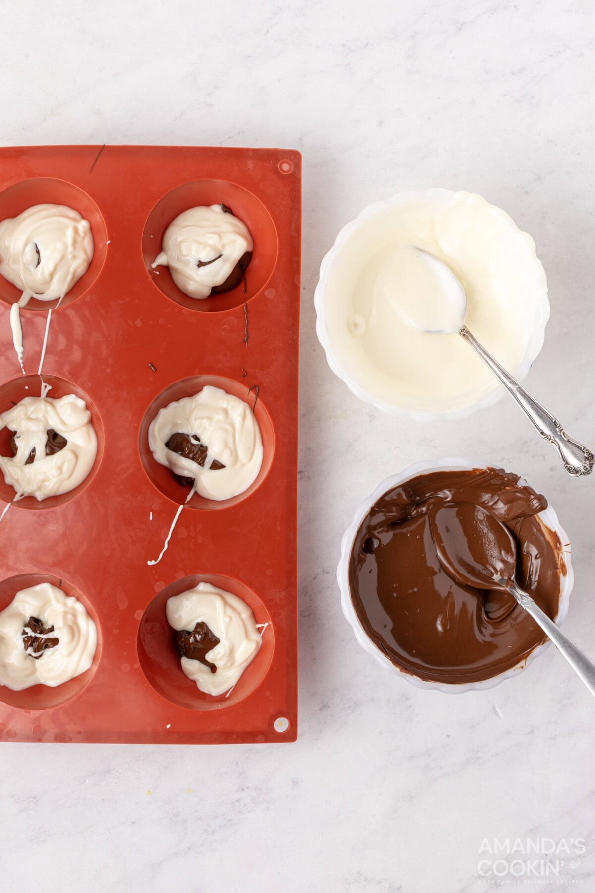 adding chocolate to cocoa bomb molds