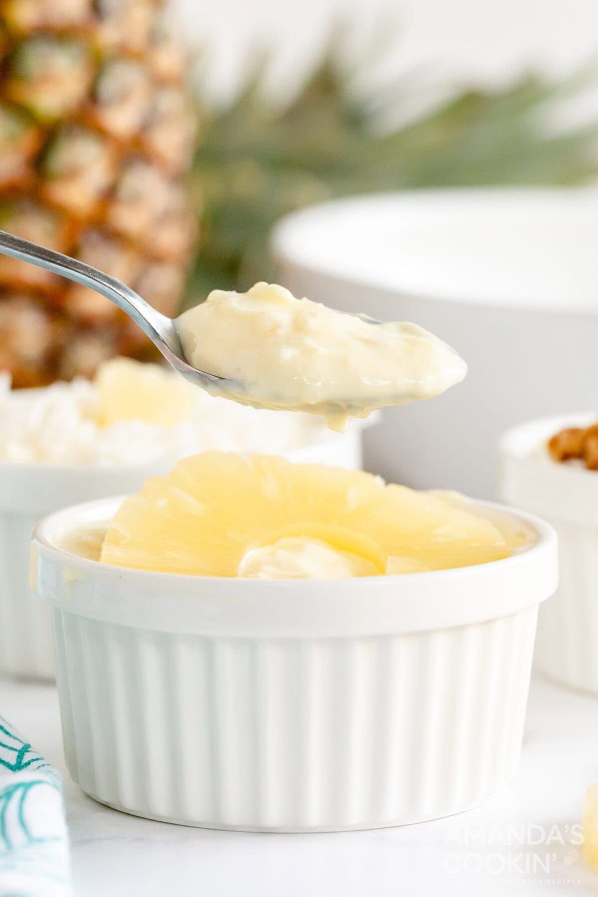 lifting spoon from pineapple yogurt dessert