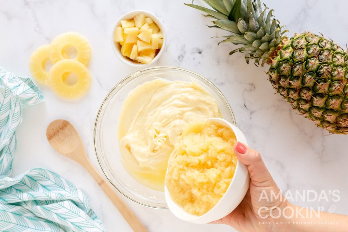 adding pineapple to bowl