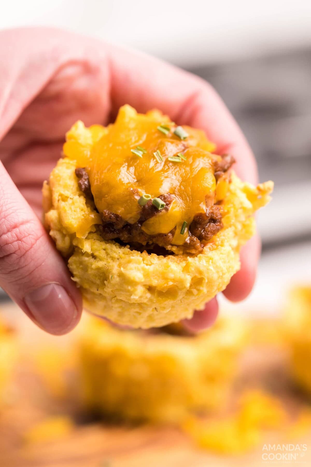 woman holding a Sloppy Joe Corn Muffin