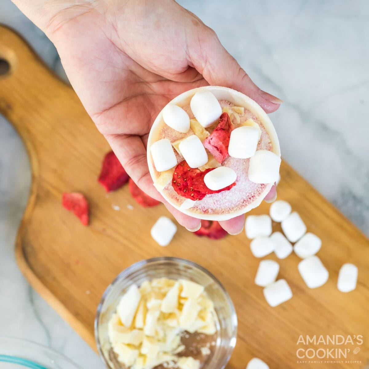 adding freeze dried strawberries and marshmallows to bottom of the cocoa bomb