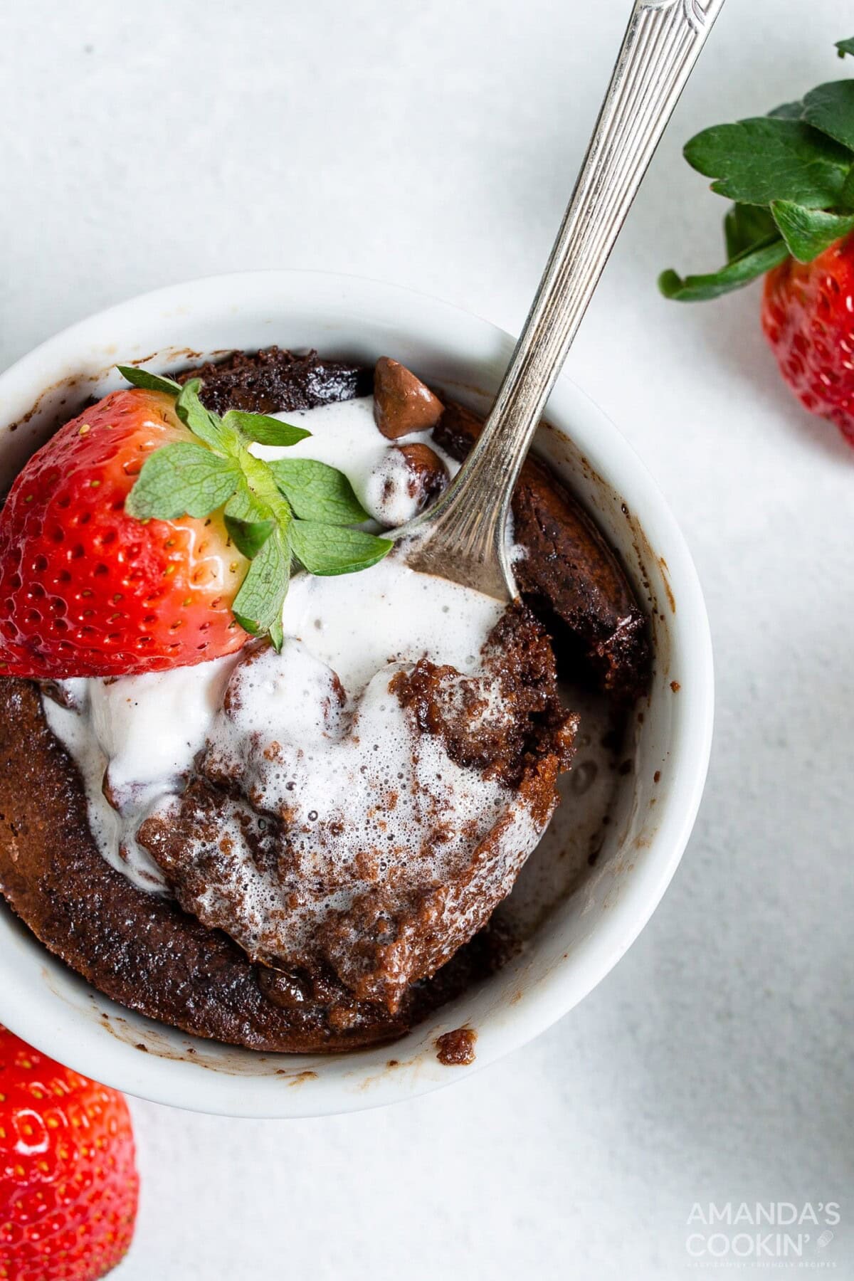 air fryer brownie in a ramekin with ice cream and strawberries