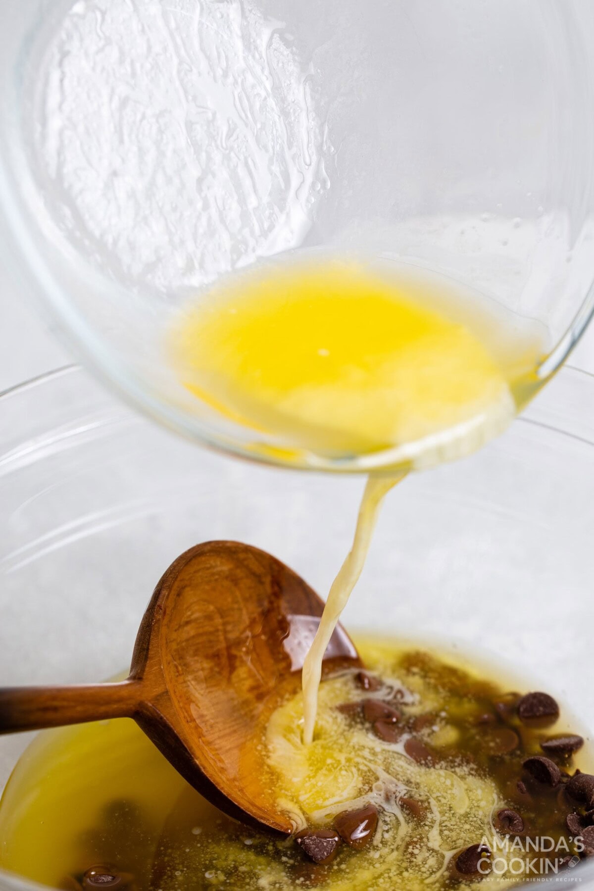 pouring melted butter over chocolate chips