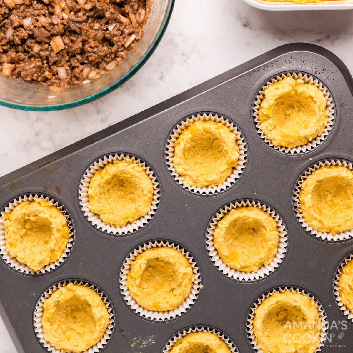 center of cornbread removed in a muffin tin