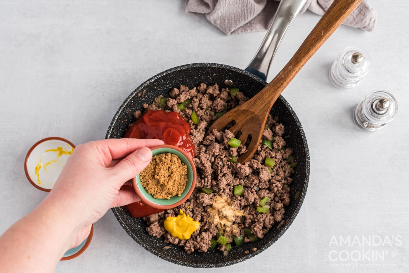 adding wet ingredients and spices to skillet