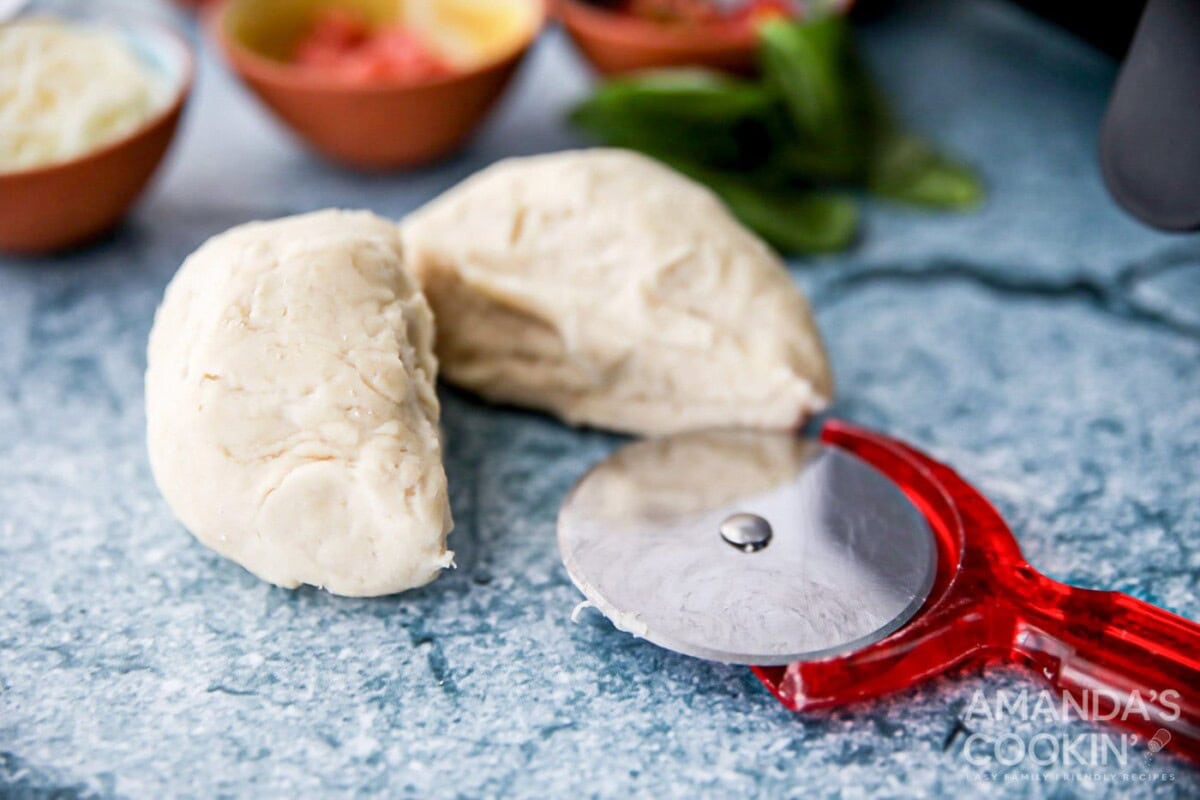pizza dough cut in half