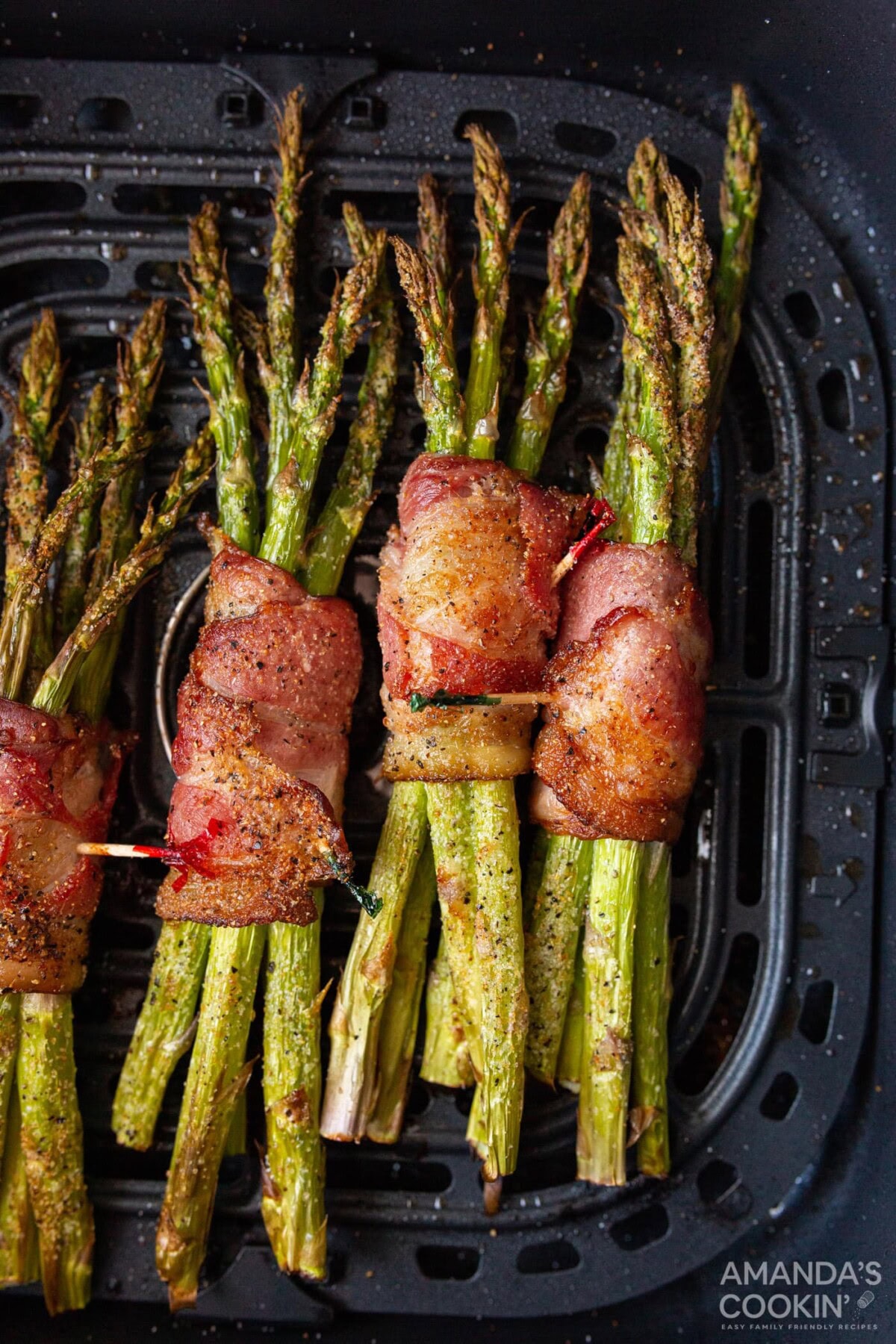 Bacon Wrapped Asparagus in an air fryer basket