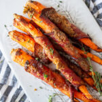 candied bacon wrapped carrots on a plate