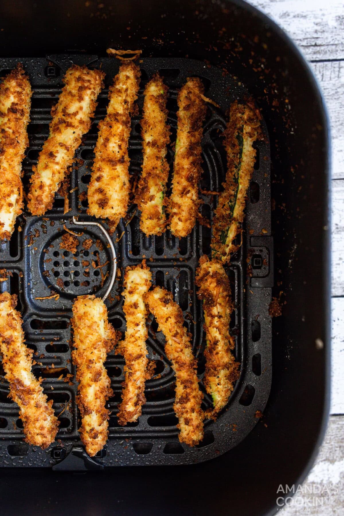 air fryer zucchini fries in an air fryer basket