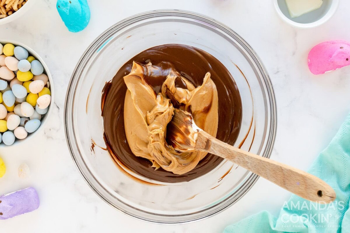 Peanut butter being mixed in with melted chocolate