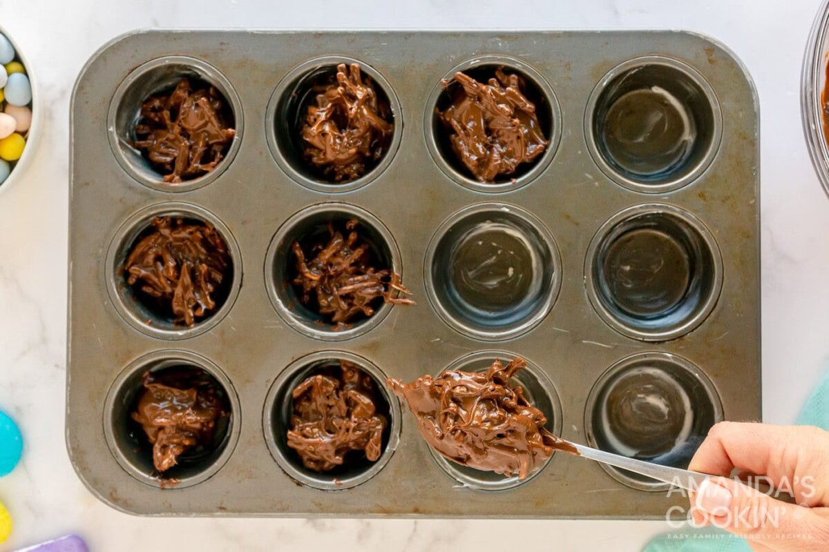 spooning bird nest cookie mixture into muffin pan