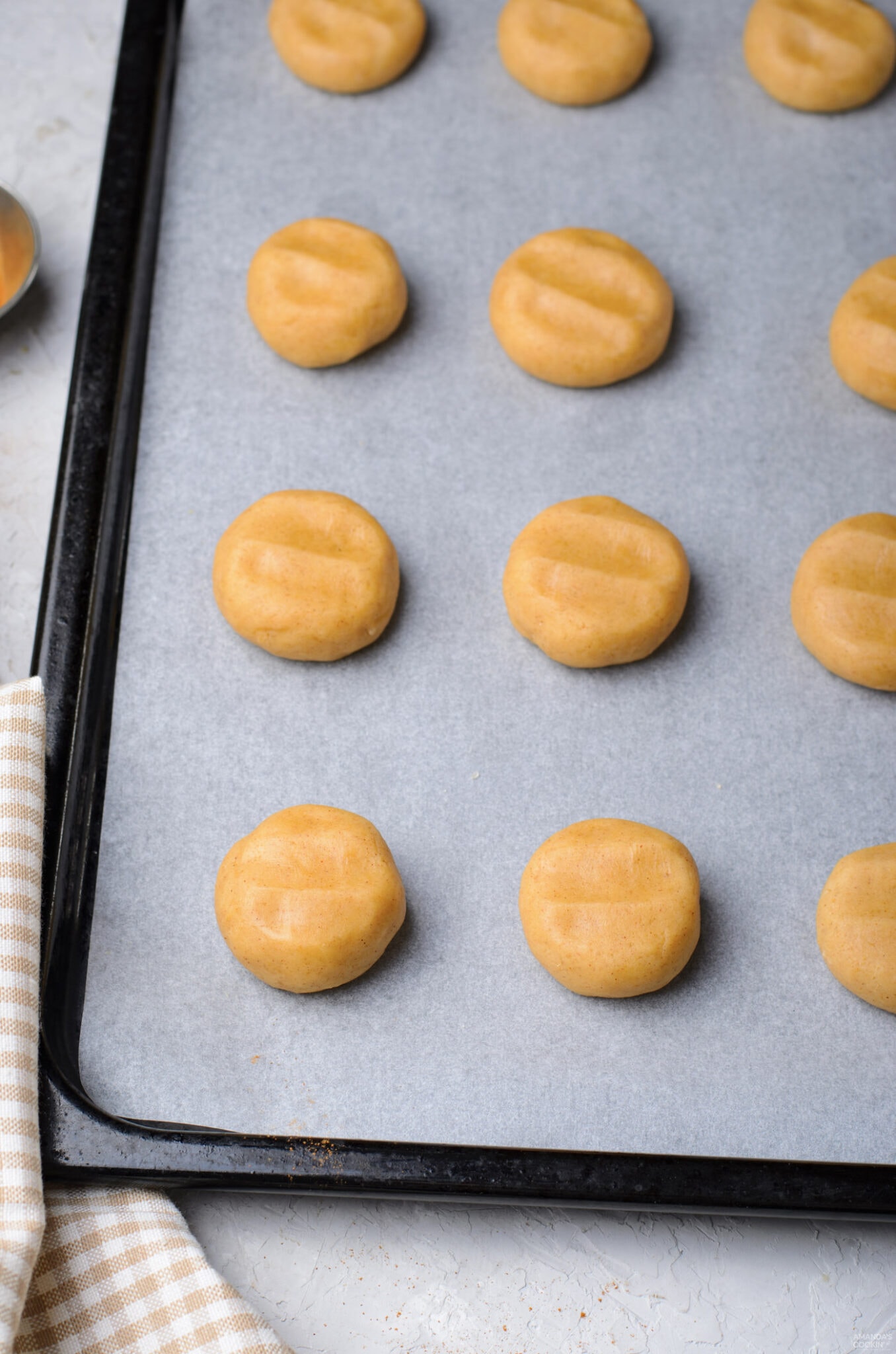 flattened dough balls on baking sheet