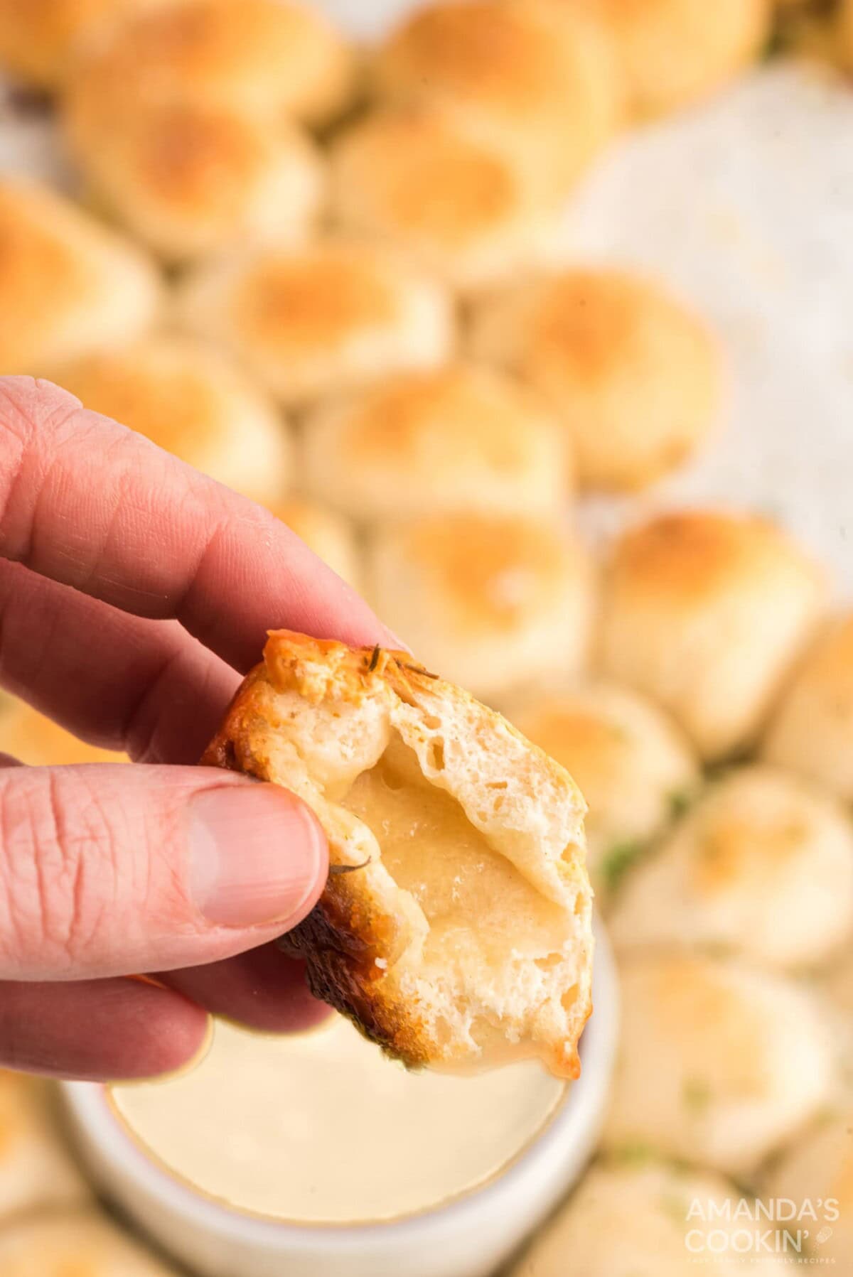hand holding cheese filled bread ball