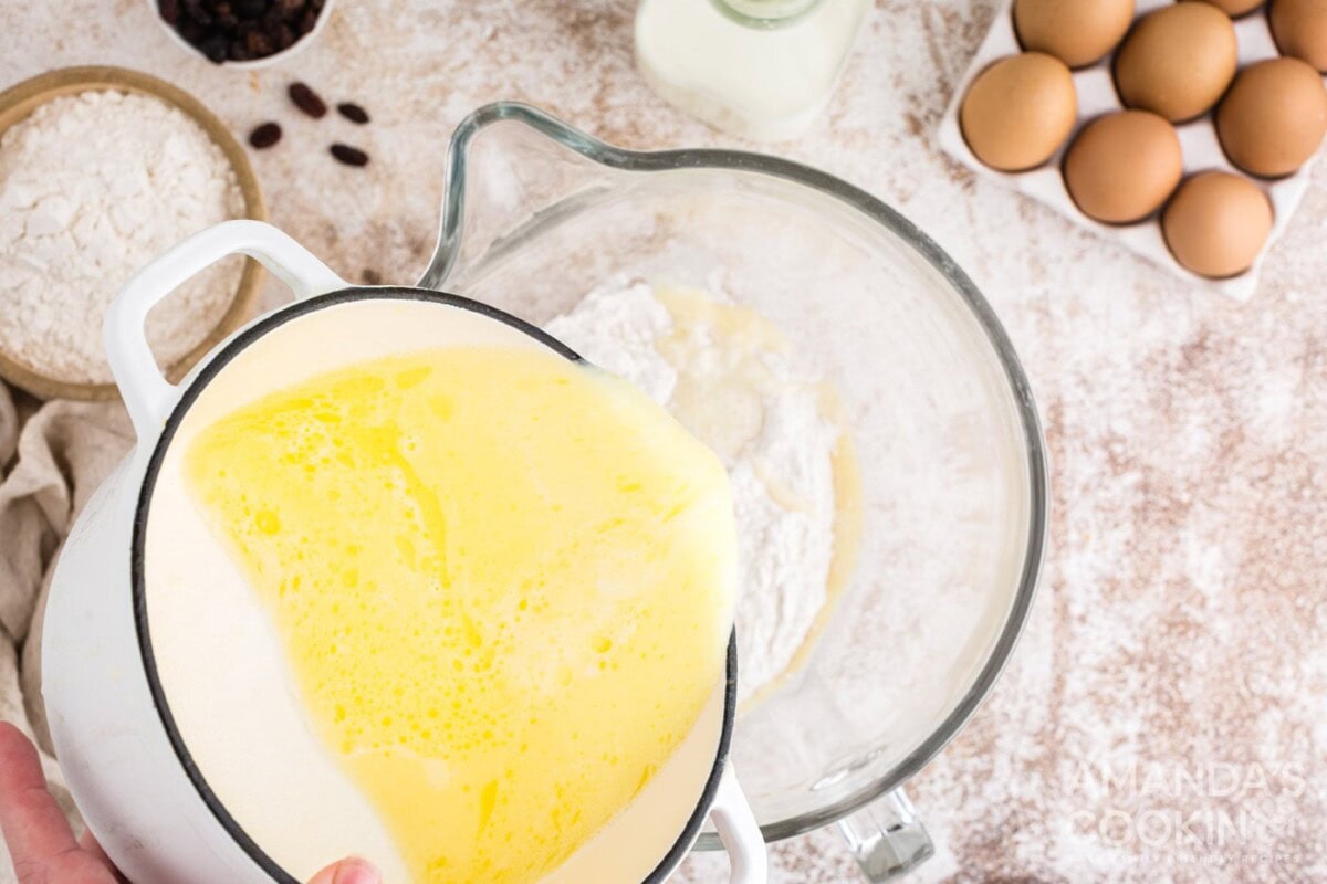 adding wet ingredients into dry ingredients in mixer bowl