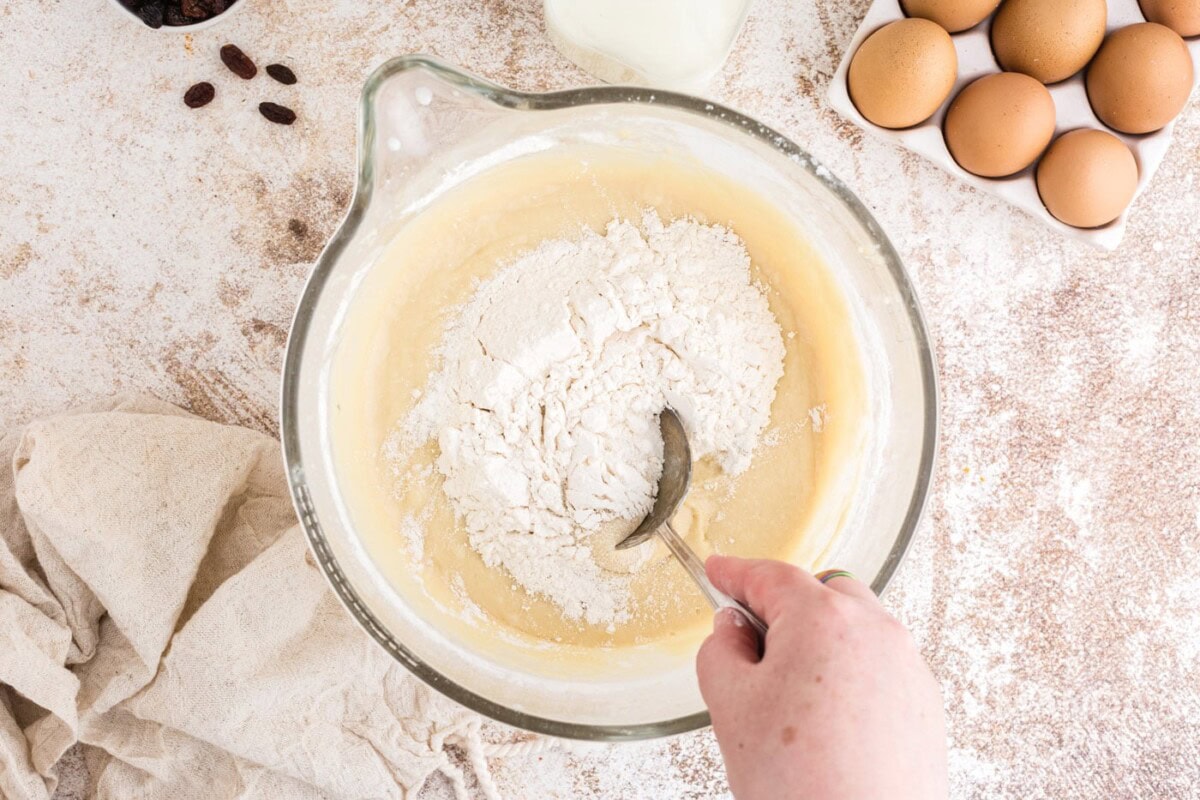 stirring extra flour in mixing bowl with a spoon
