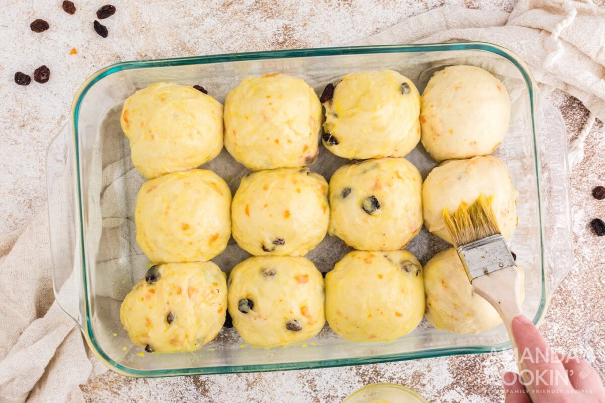 brushing tops of dough balls with eggwash