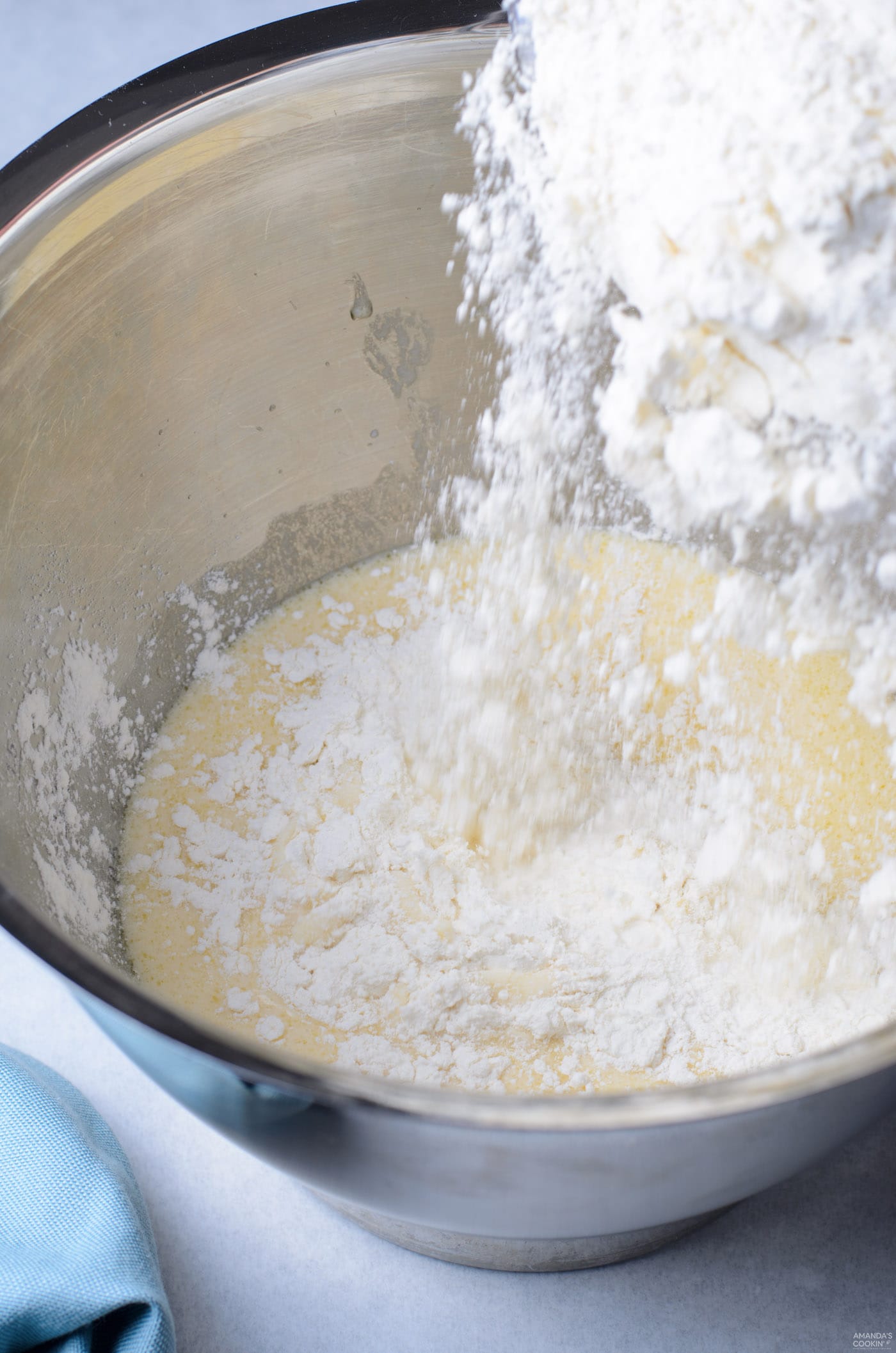 pouring flour into yeast mixture