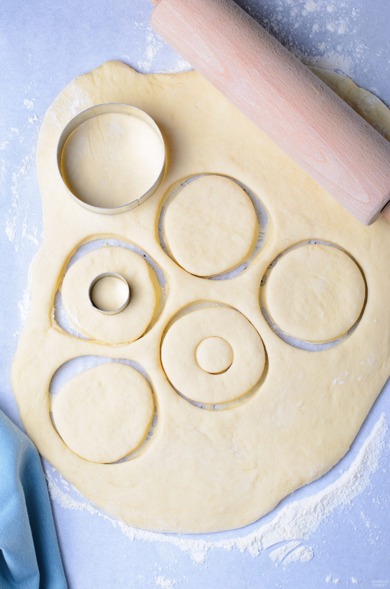 cutting donuts out of dough