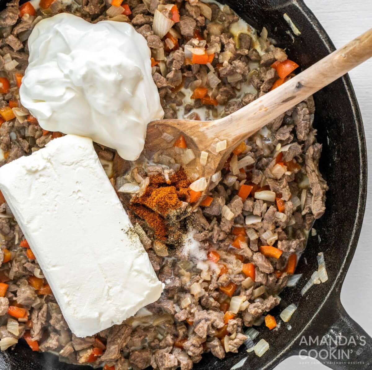 sour cream and cream cheese added to meat mixture in a skillet