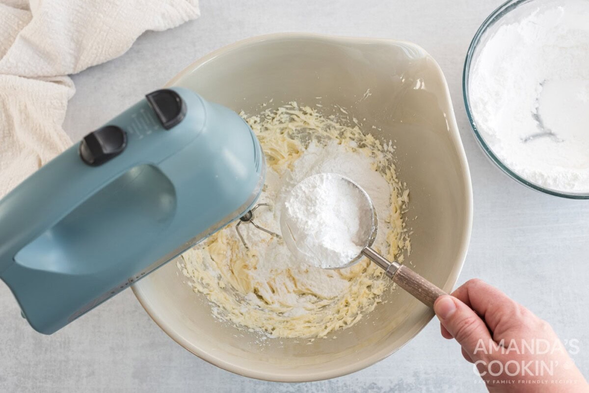 adding powdered sugar to mixer bowl