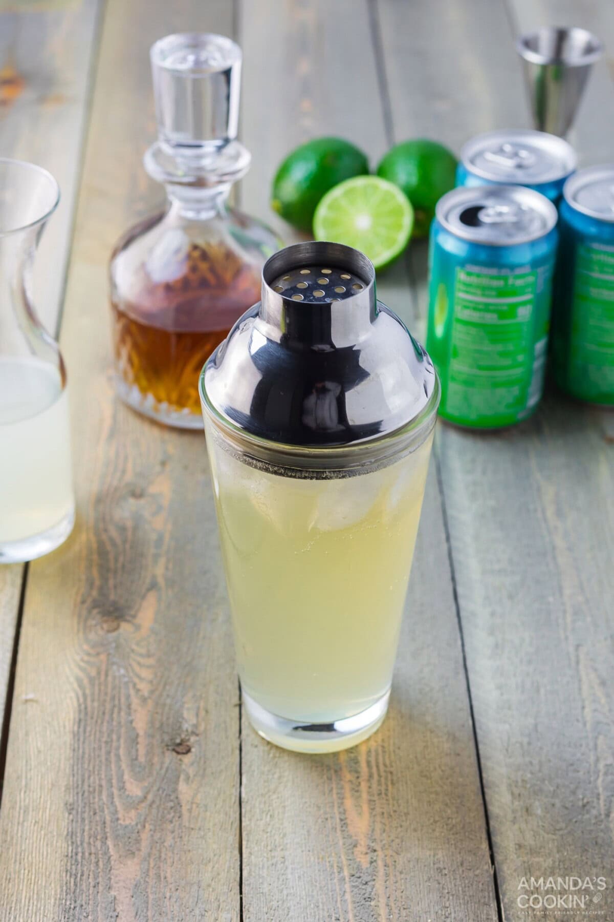 spiked limeade with cocktail shaker lid on glass