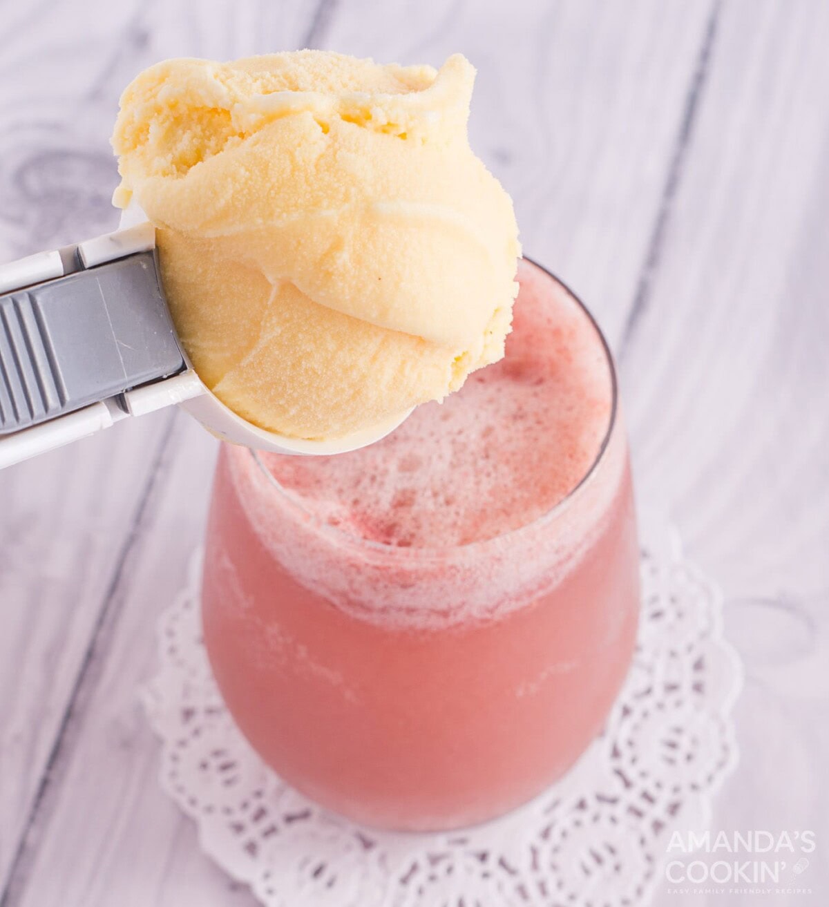 scoop of vanilla ice cream over strawberry banana float