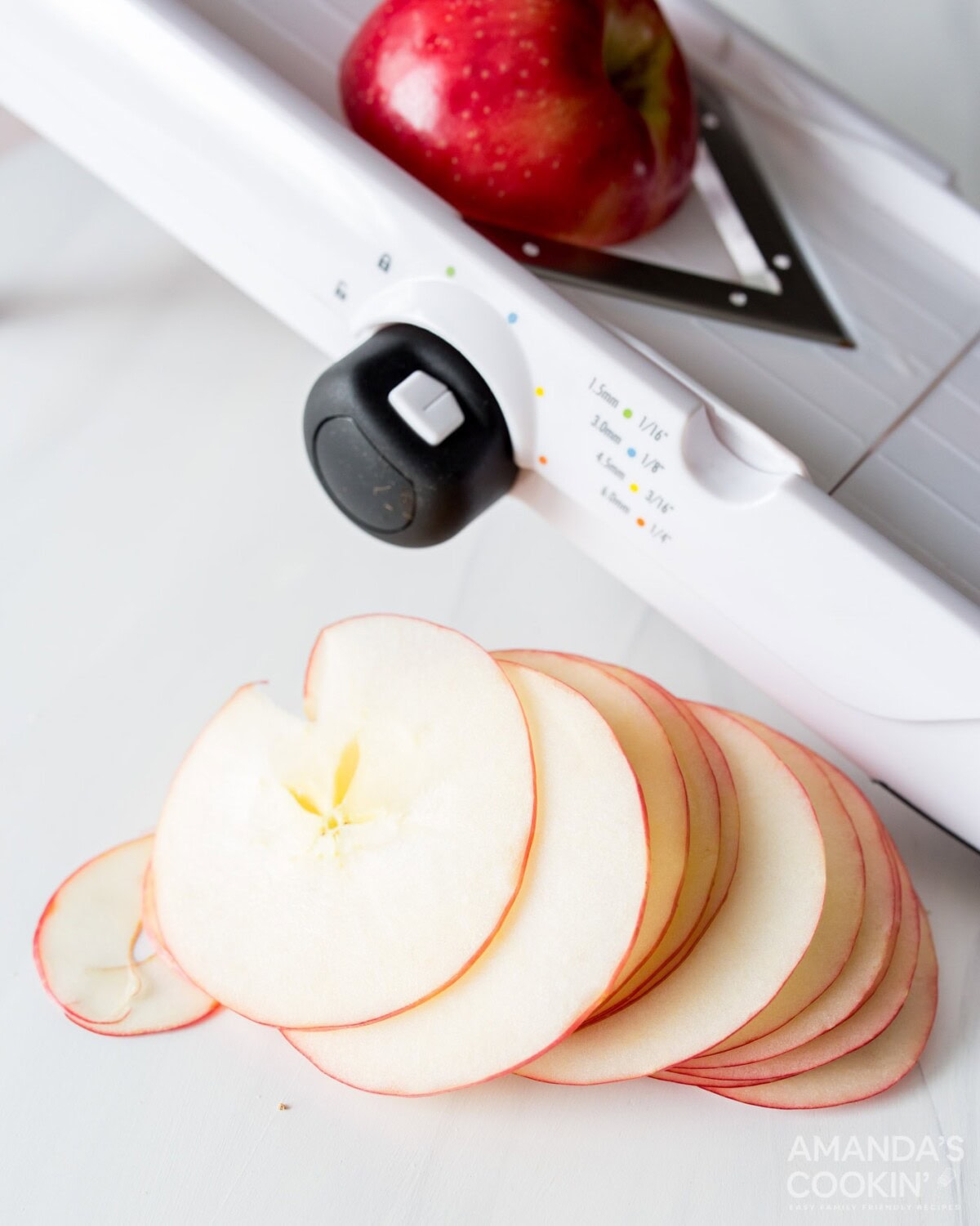 sliced apples next to a mandolin