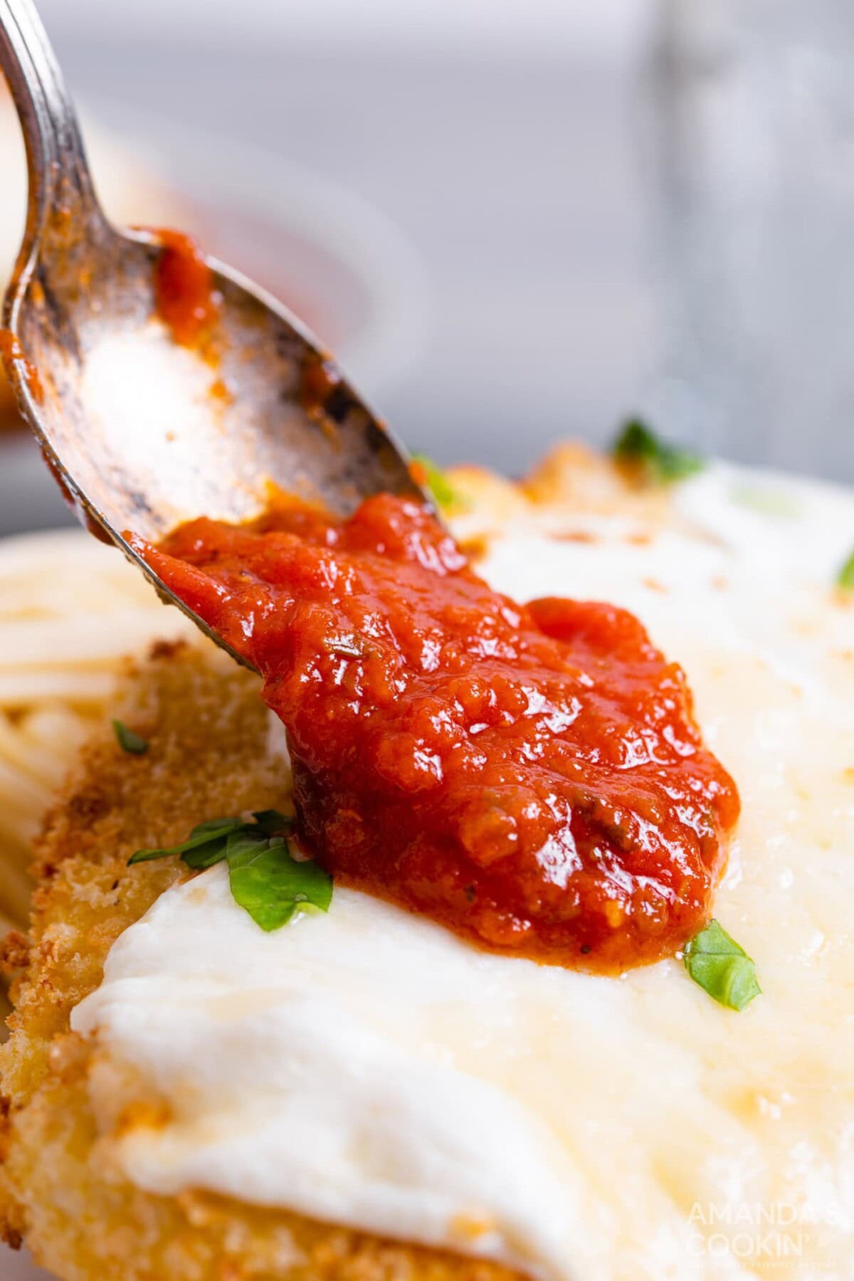 spooning sauce on to chicken