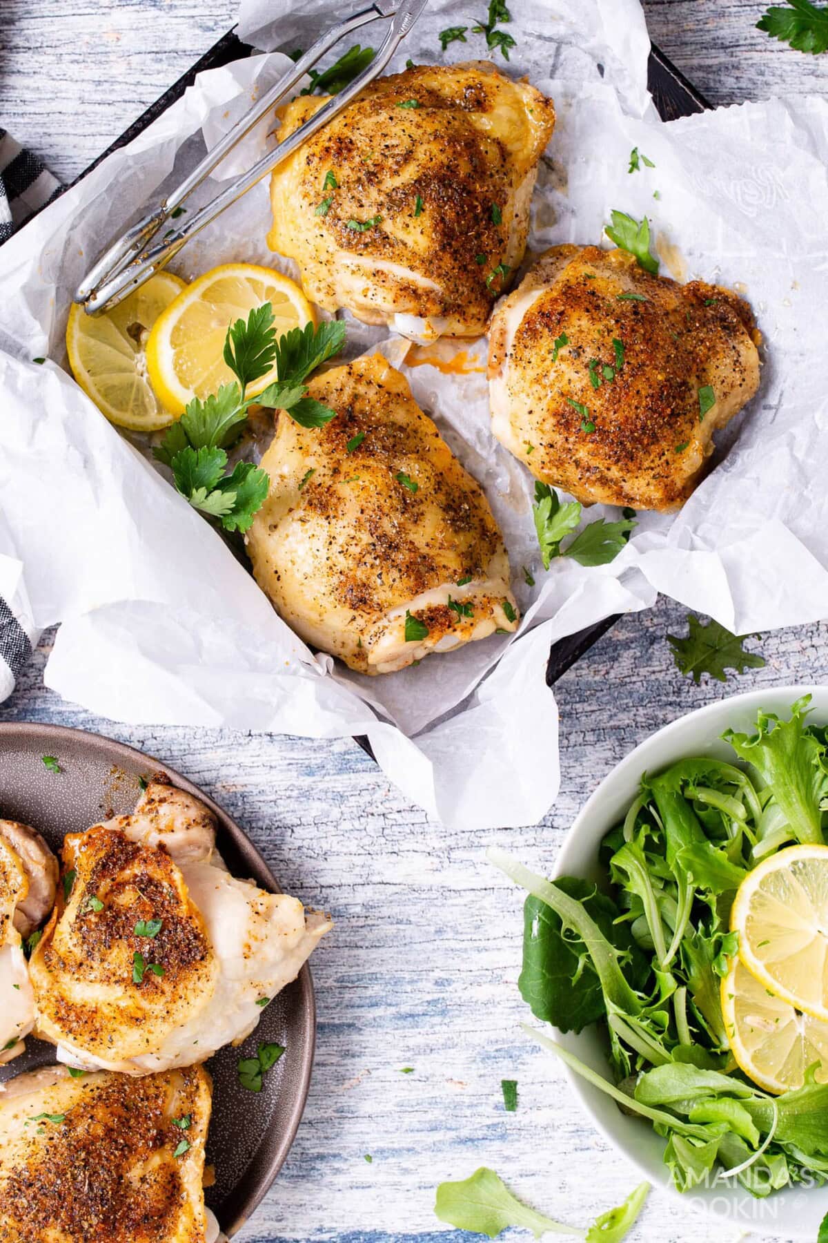 air fryer chicken thighs in a square pan with salad