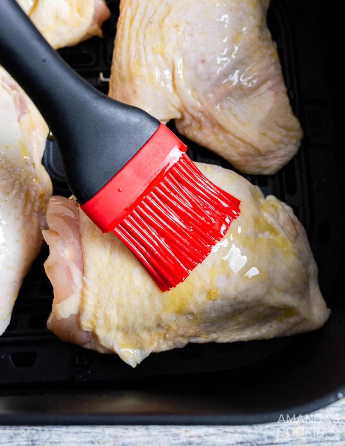 brushing chicken thighs with oil