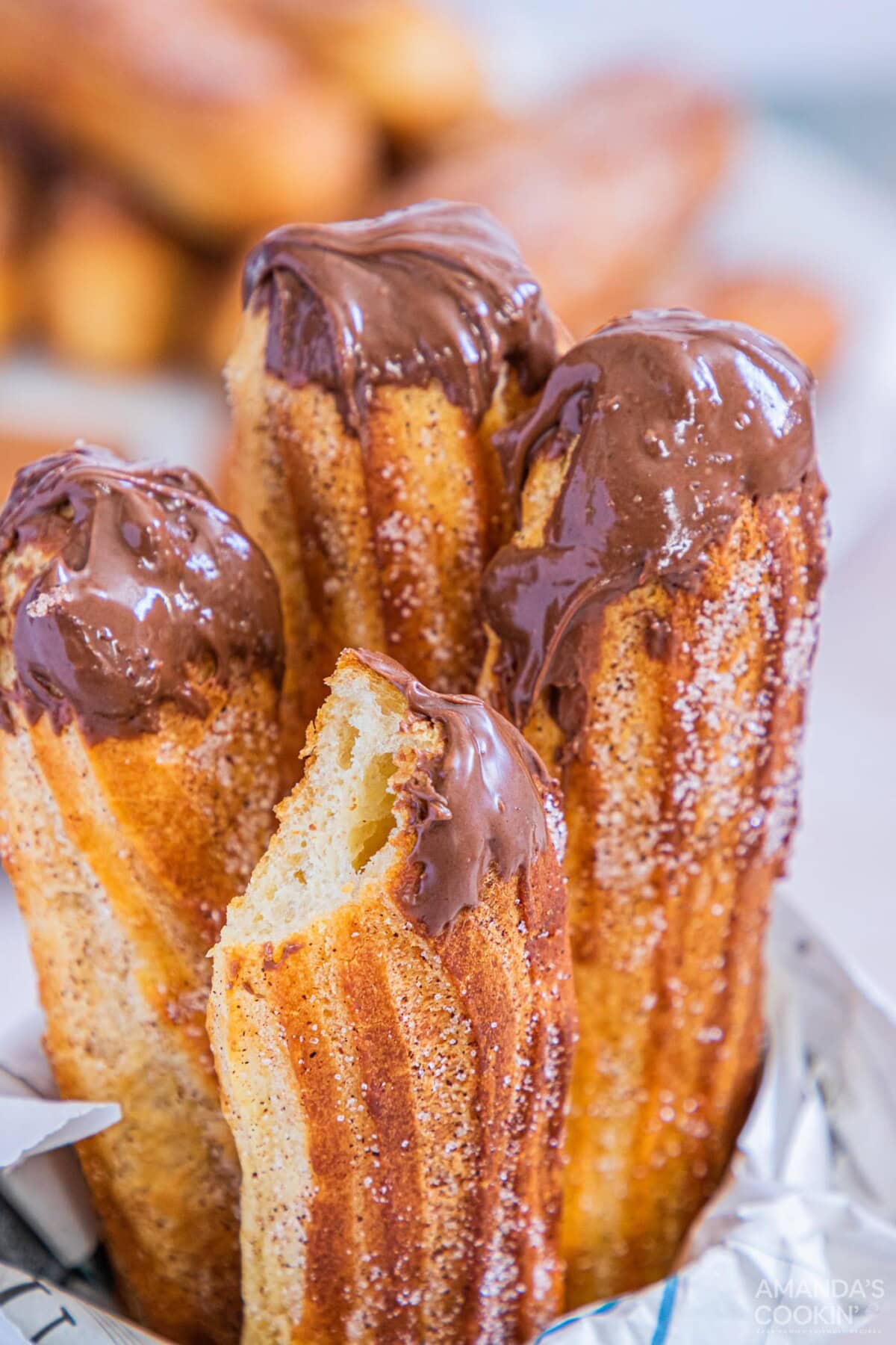 Air Fryer Churros with nutella sauce and a bit out of one of them
