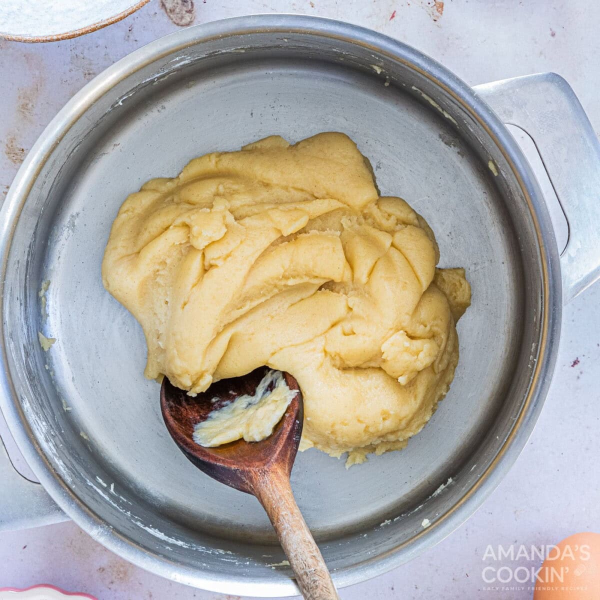 stirring dough with wooden spoon