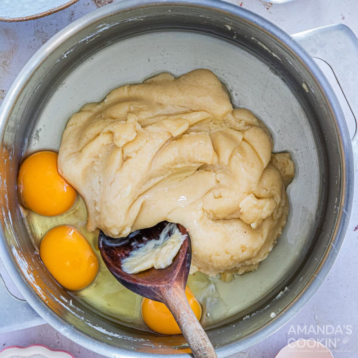 stirring eggs into dough batter