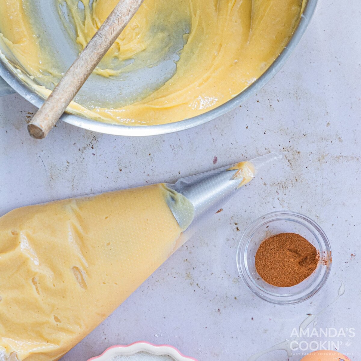 churro dough in a piping bag with tip