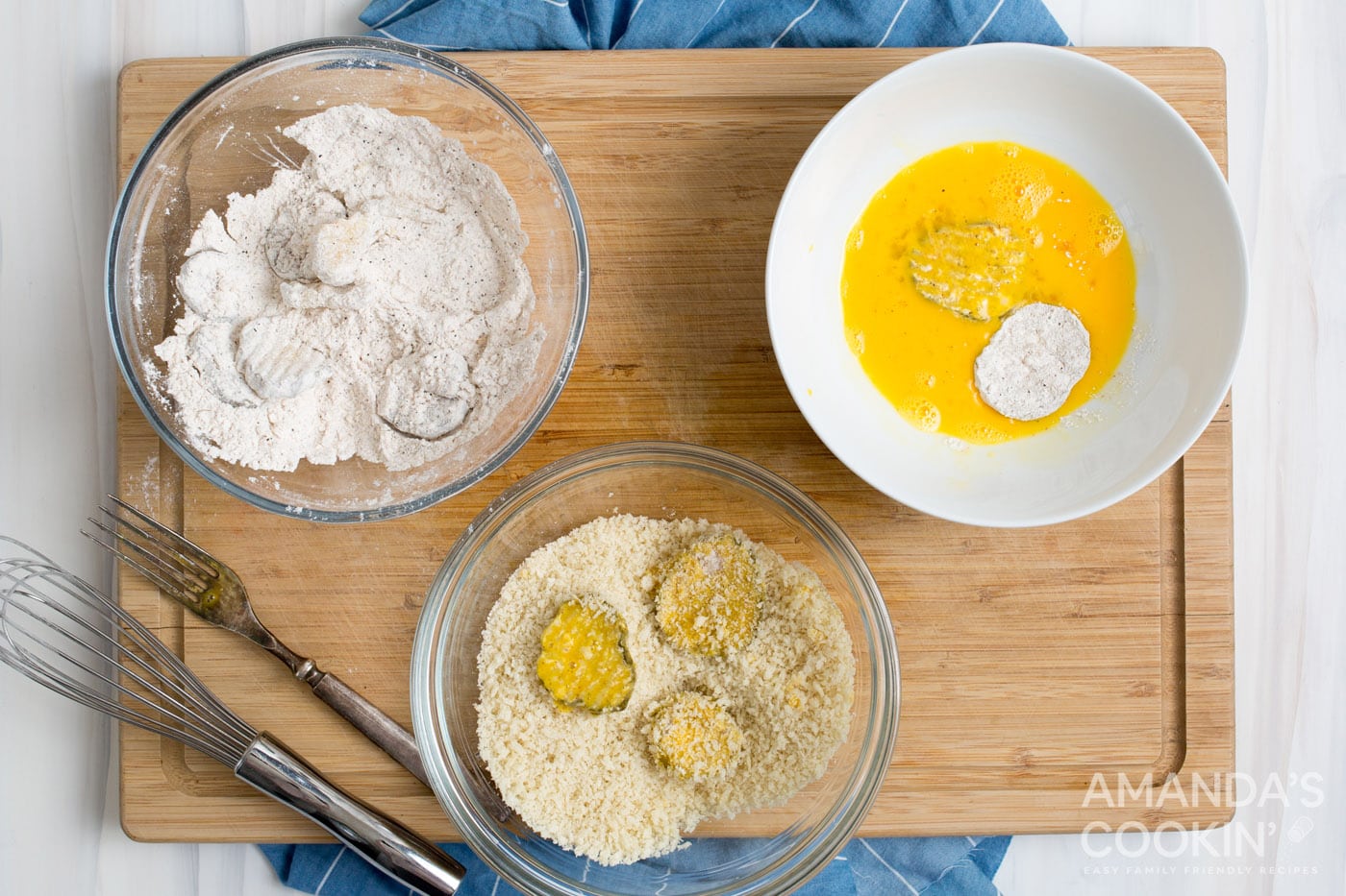 dipping pickles in egg, panko, and flour