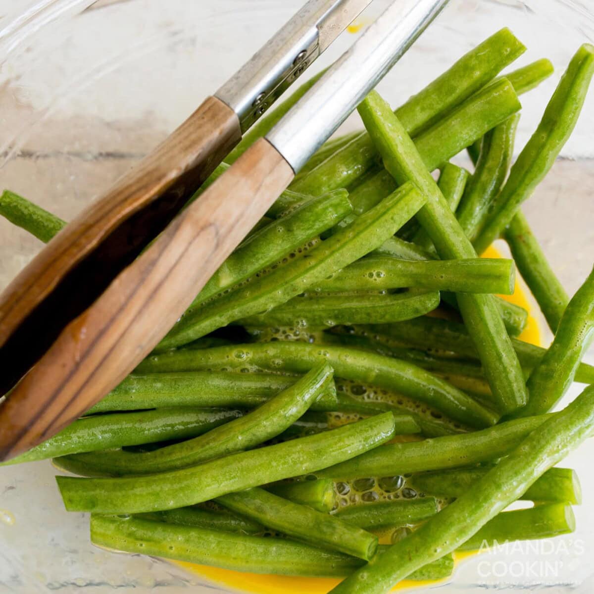 tossing green beans in a bowl of eggs