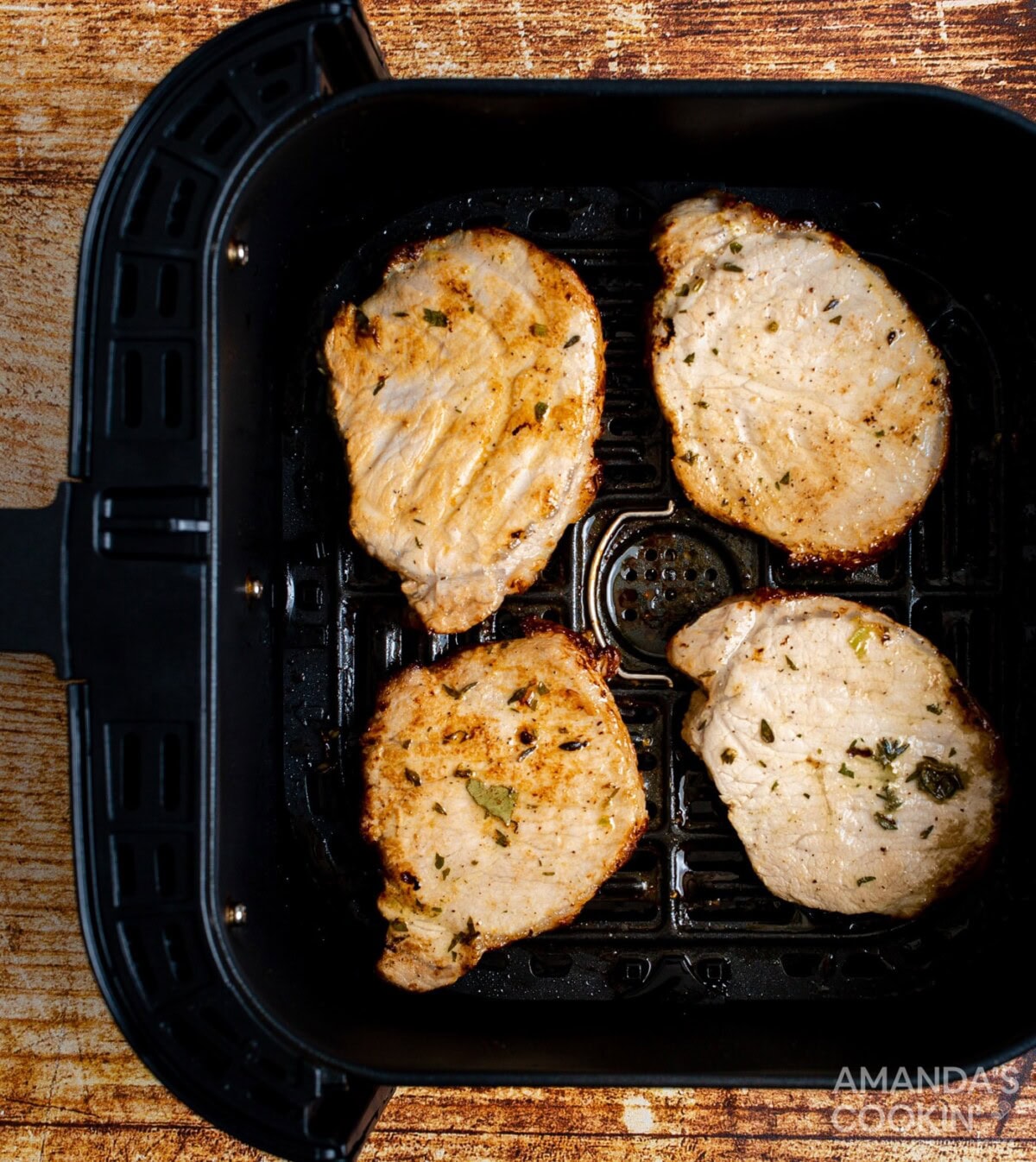 pork chops in an air fryer basket
