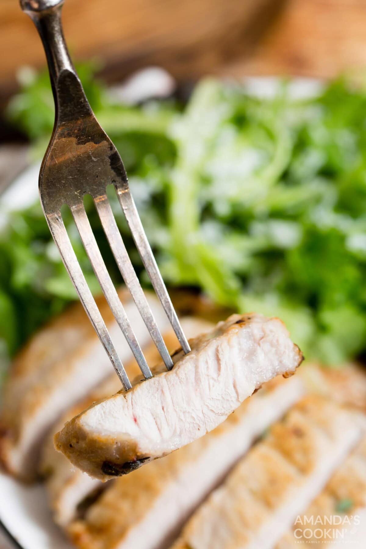 sliced pork chop on a fork