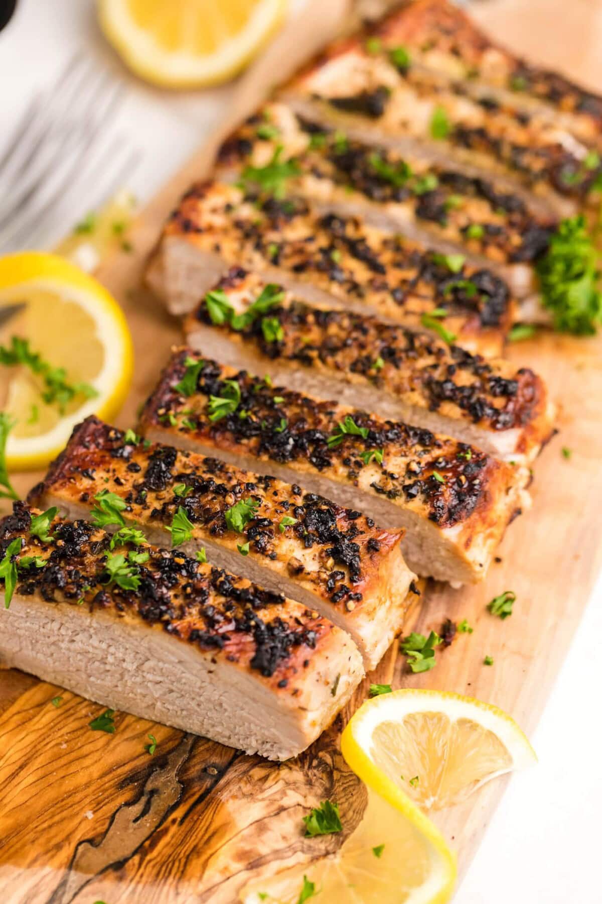 sliced Air Fryer Pork Tenderloin on a cutting board